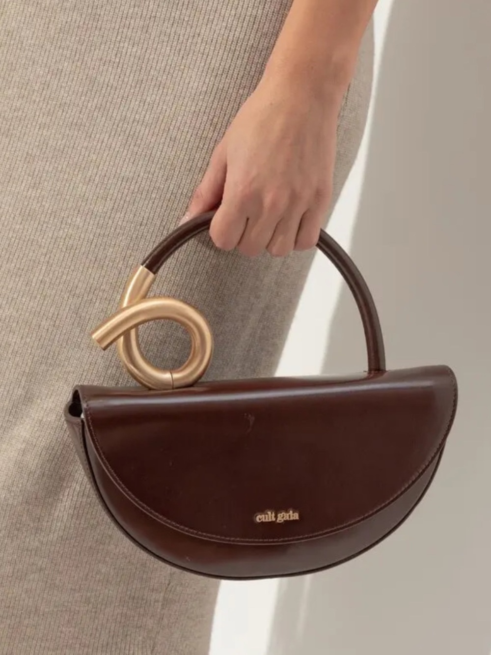 cult gaia Azariah dark brown half-moon top handle bag with gold-tone knot